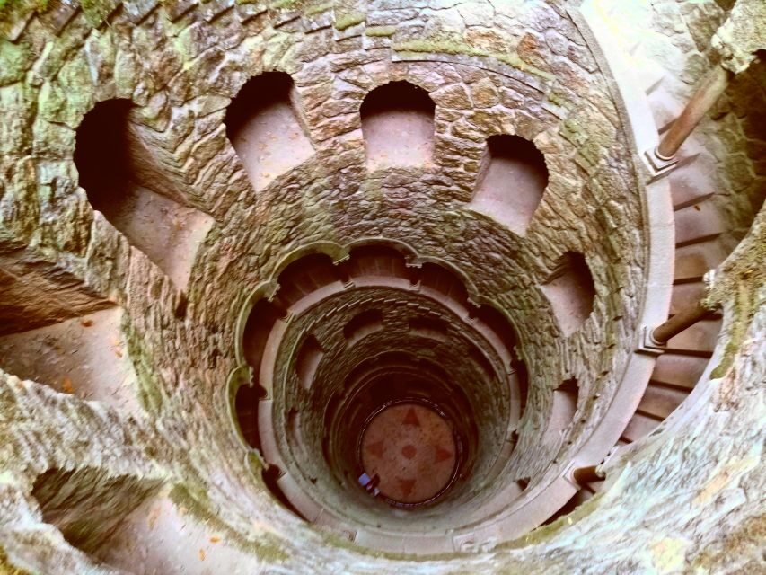 Sintra: Immersive Guided Walking Tour w/ Quinta da Regaleira - National Palace area: architecture, the mountain, and a Moorish Castle backdrop